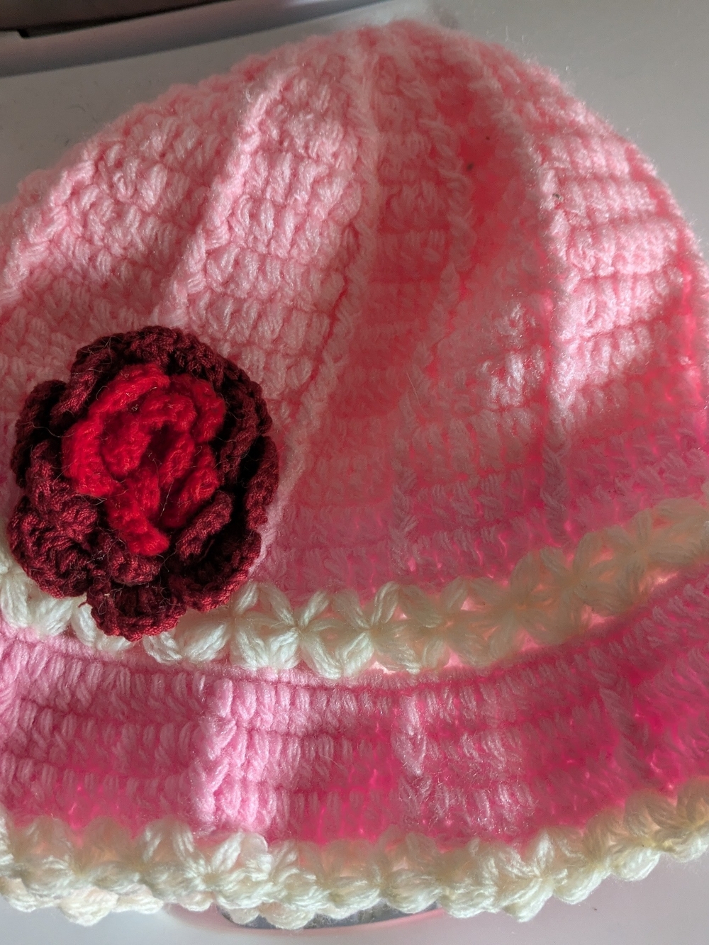 Pink Crochet Beanie with Red Flower Accent